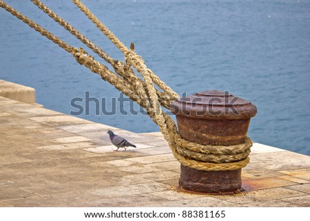 stock-photo-rusty-mooring-bollard-with-ship-ropes-on-zadar-docks-88381165.jpg